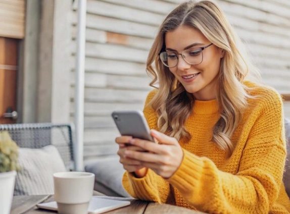 Woman looking at caravan loans on phone