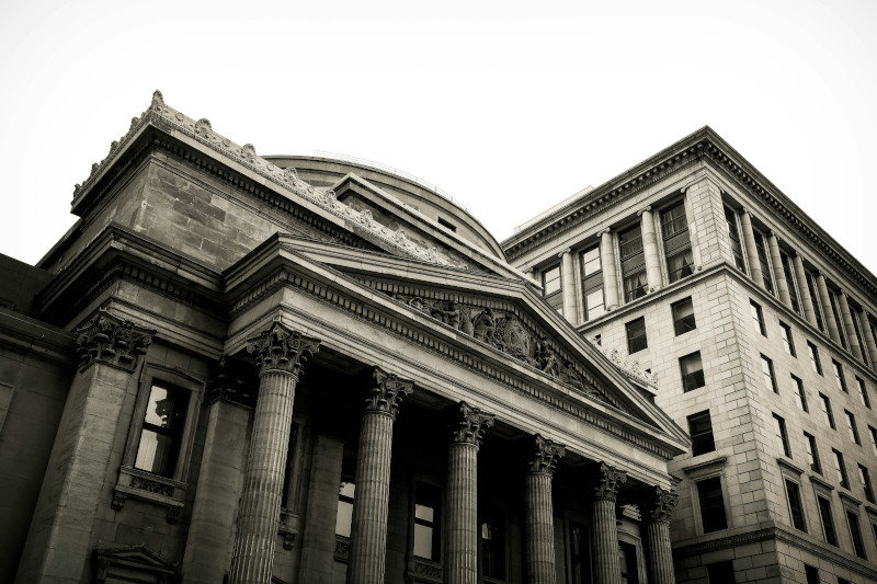 An image of an old grey bank and buildings